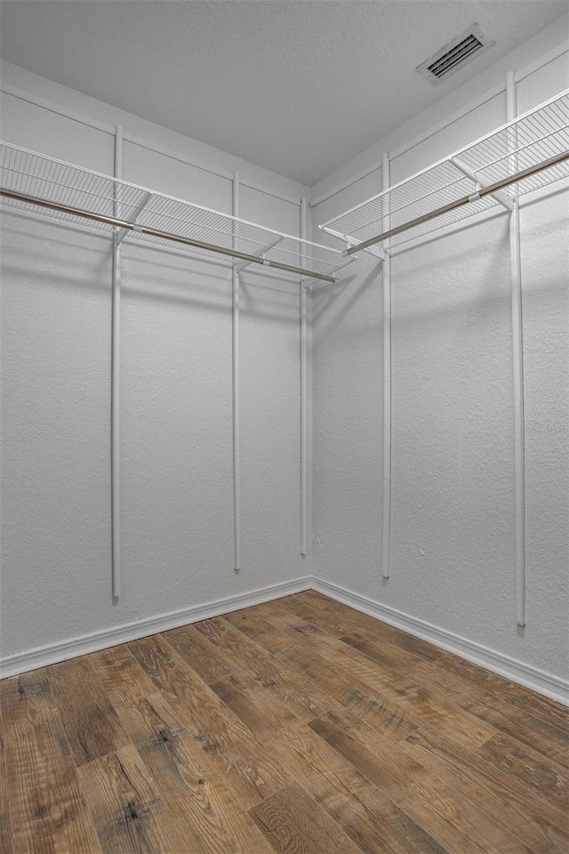 spacious closet with hardwood / wood-style floors