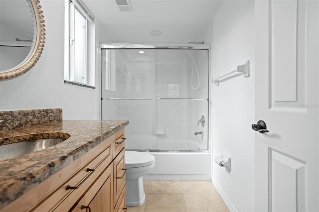 full bathroom featuring shower / bath combination with glass door, tile patterned flooring, toilet, and vanity