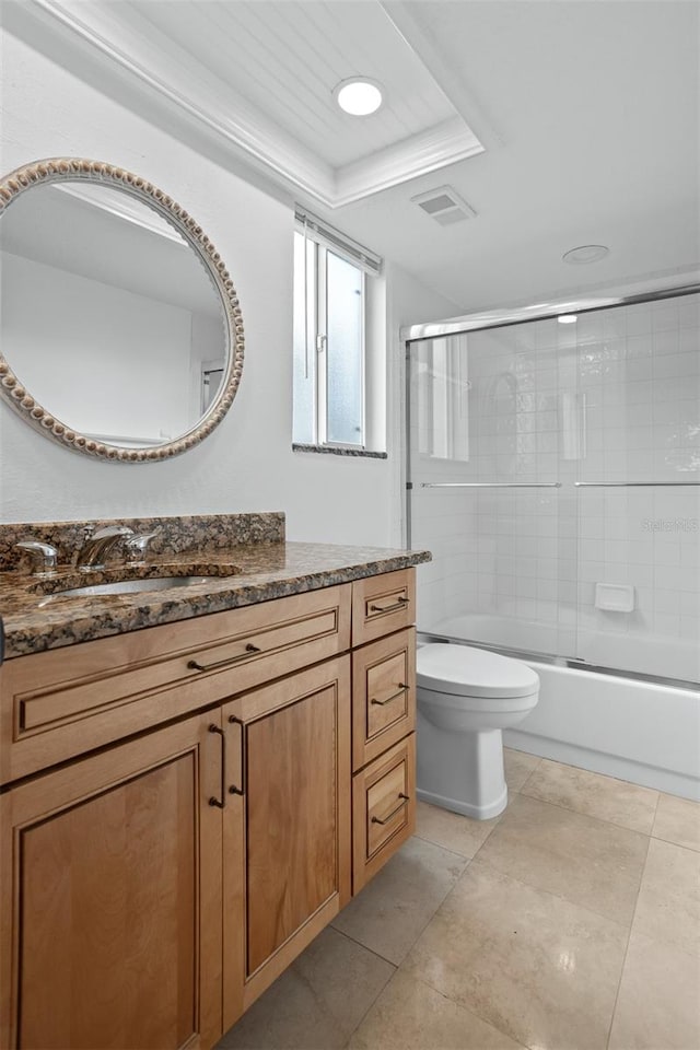 full bathroom with toilet, vanity, bath / shower combo with glass door, and tile patterned flooring