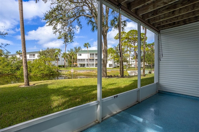 unfurnished sunroom featuring a water view