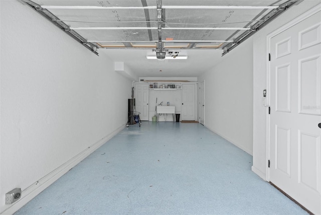 garage with a garage door opener and sink