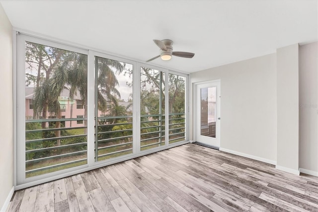 unfurnished sunroom with ceiling fan and a healthy amount of sunlight