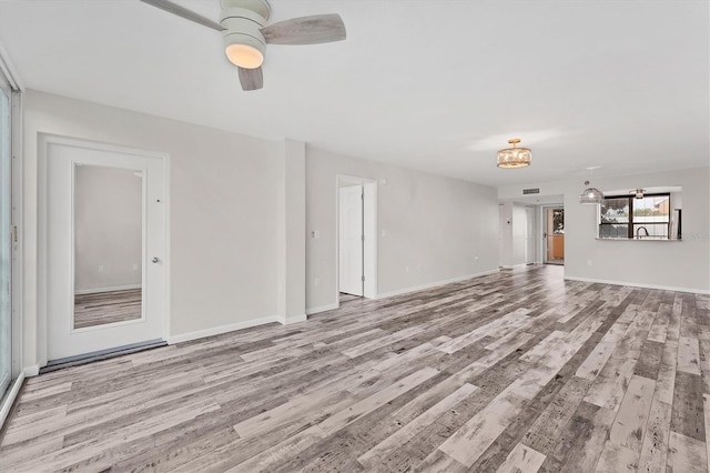 unfurnished living room featuring light hardwood / wood-style floors and ceiling fan