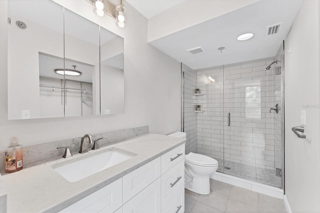 bathroom with toilet, an enclosed shower, vanity, and tile patterned flooring