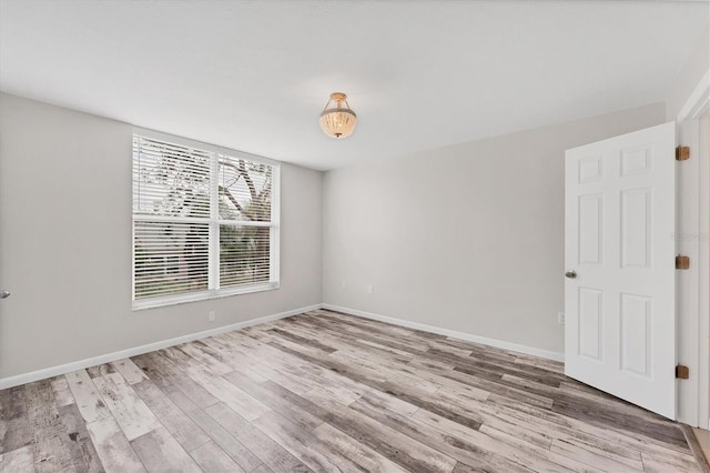 unfurnished room with light hardwood / wood-style flooring