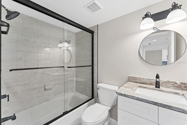 full bathroom with shower / bath combination with glass door, vanity, and toilet