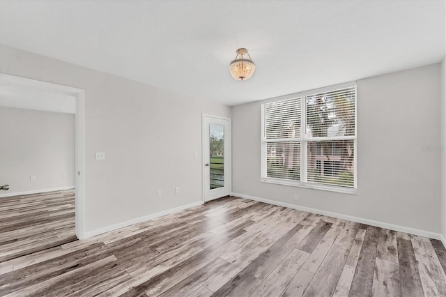 unfurnished room featuring hardwood / wood-style floors