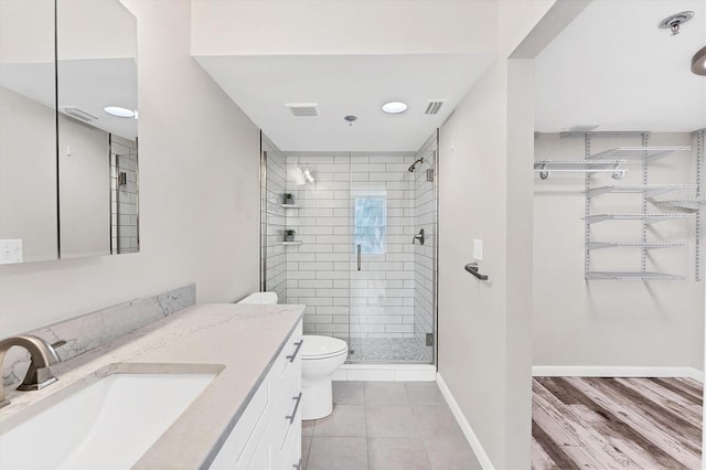 bathroom with hardwood / wood-style flooring, vanity, toilet, and an enclosed shower