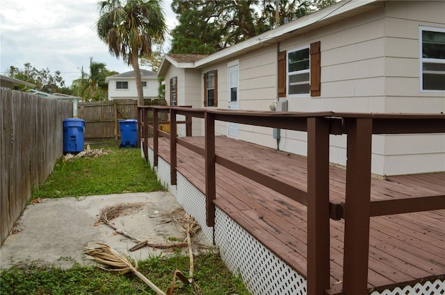 view of side of home with a lawn, a patio area, and a wooden deck