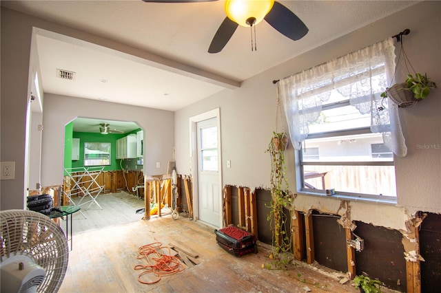 miscellaneous room with ceiling fan, beam ceiling, and wood-type flooring