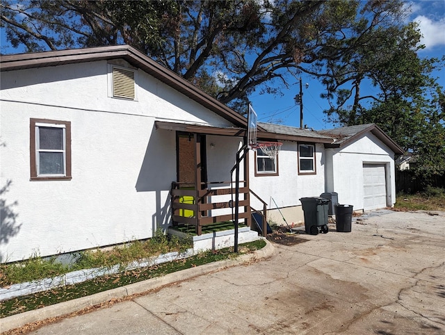 view of side of home featuring a garage and an outdoor structure