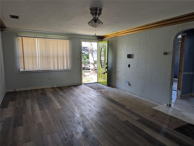 foyer entrance with ceiling fan, dark hardwood / wood-style floors, and crown molding