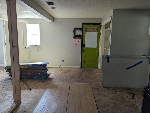 interior space with hardwood / wood-style floors and a textured ceiling