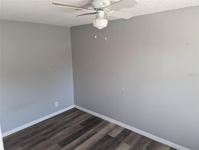 spare room with dark wood-type flooring, ceiling fan, and a textured ceiling