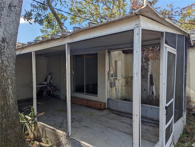 exterior space with a sunroom and a patio area