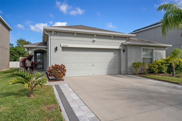 view of front of property with a garage and a front yard