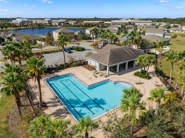 view of pool featuring a water view and a patio area