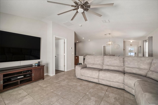 tiled living room featuring a textured ceiling and ceiling fan