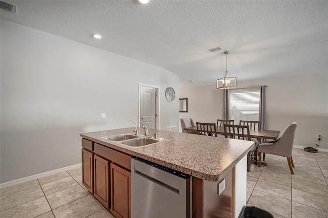 kitchen with dishwasher, hanging light fixtures, a textured ceiling, sink, and an island with sink