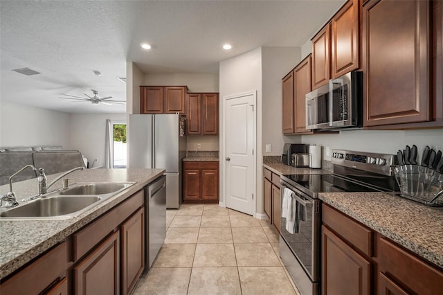 kitchen with sink, appliances with stainless steel finishes, ceiling fan, a textured ceiling, and light tile patterned floors