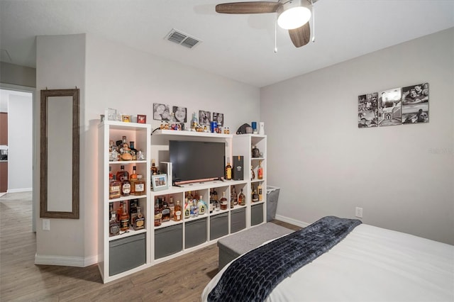 bedroom with ceiling fan and wood-type flooring