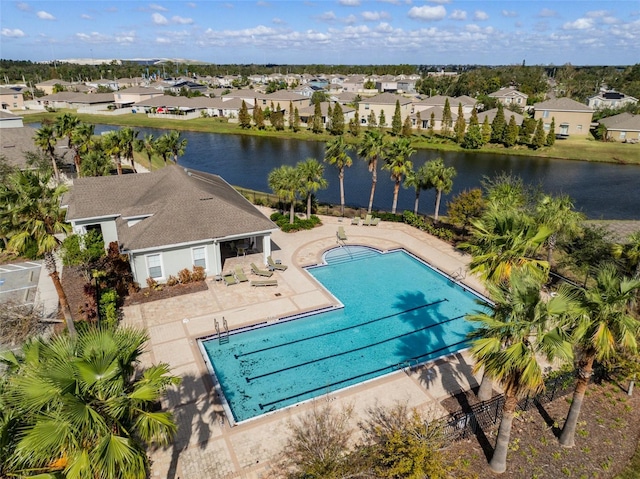 view of swimming pool featuring a patio and a water view