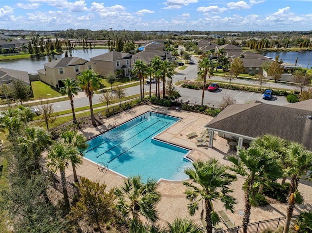 view of swimming pool with a water view and a patio area