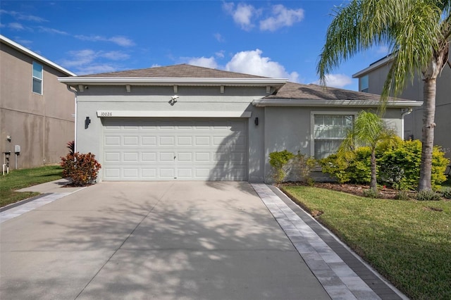 single story home with a garage and a front yard