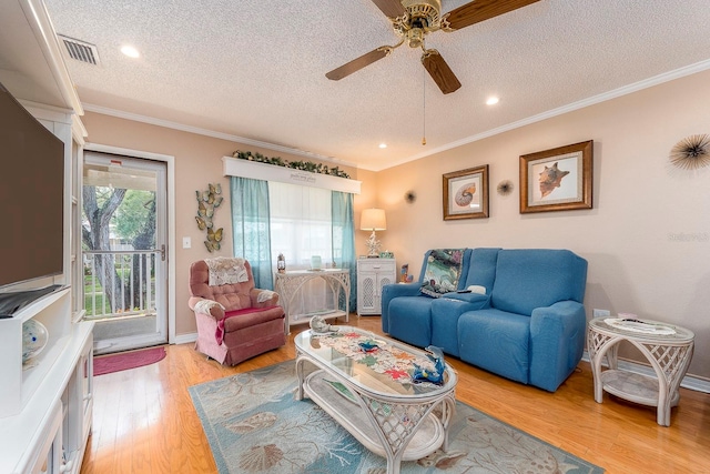 living room with crown molding, light wood-type flooring, a textured ceiling, and ceiling fan