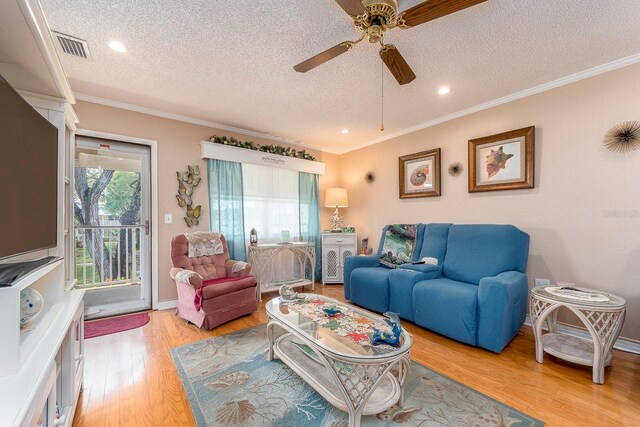 10036 63rd Ave N Unit 23, Saint Petersburg, FL 33708 - living area with a textured ceiling, light wood finished floors, crown molding, a ceiling fan, and recessed lighting
