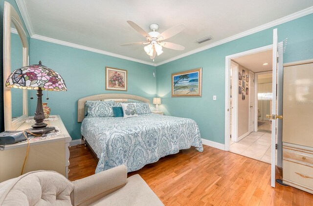 10036 63rd Ave N Unit 23, Saint Petersburg, FL 33708 - bedroom featuring crown molding, baseboards, wood finished floors, and a ceiling fan