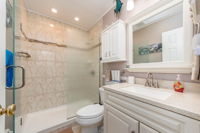 bathroom featuring an enclosed shower, vanity, and toilet