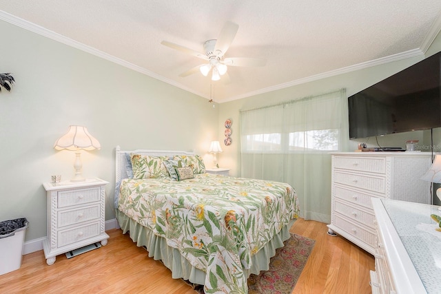 bedroom with ceiling fan, a textured ceiling, light wood-type flooring, and ornamental molding