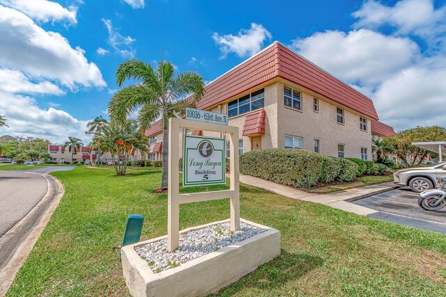 10036 63rd Ave N Unit 23, Saint Petersburg, FL 33708 - community sign featuring a yard and uncovered parking