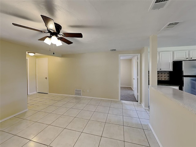 tiled empty room with ceiling fan