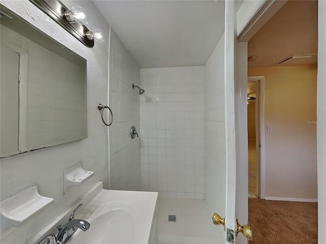 bathroom featuring sink and tiled shower