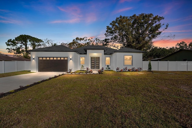 view of front of house featuring a yard and a garage