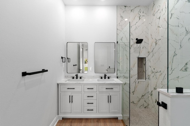 bathroom featuring vanity, tiled shower, and hardwood / wood-style floors