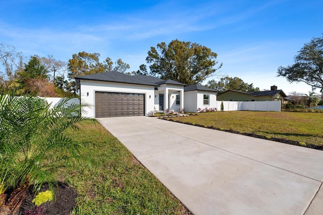 view of front of house with a garage and a front lawn