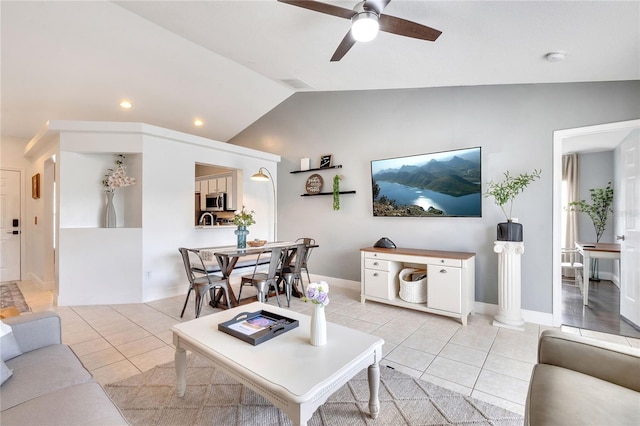 living room with lofted ceiling, light tile patterned flooring, and ceiling fan