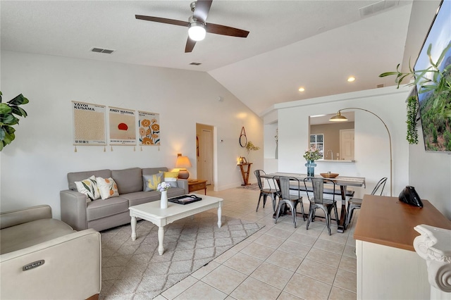 tiled living room featuring lofted ceiling and ceiling fan