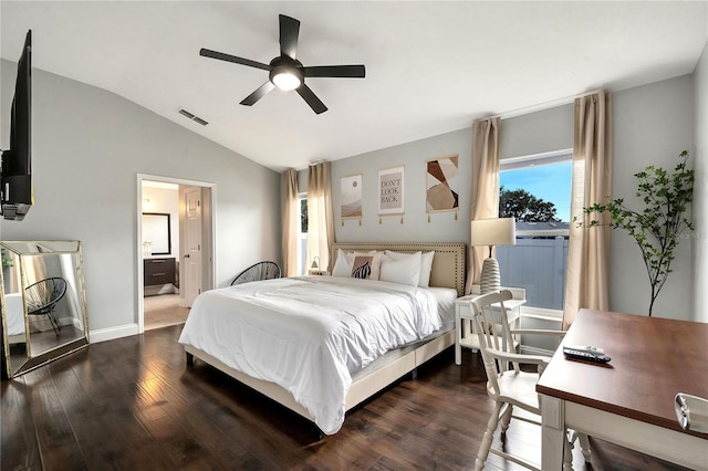 bedroom with dark wood-type flooring, ensuite bathroom, ceiling fan, and vaulted ceiling