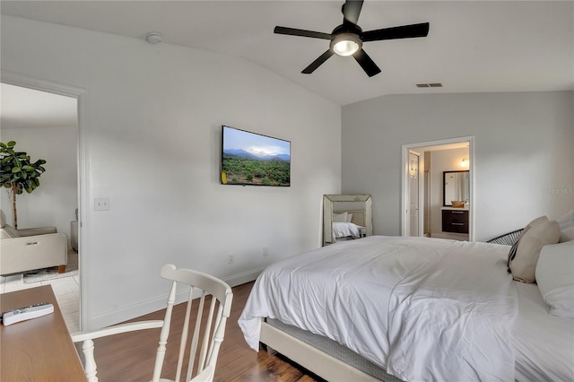 bedroom featuring connected bathroom, lofted ceiling, wood-type flooring, and ceiling fan