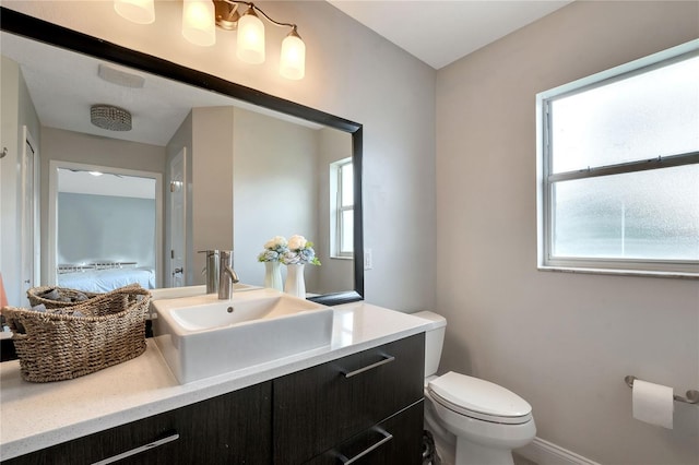 bathroom featuring toilet and vanity