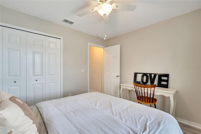 bedroom featuring a closet, hardwood / wood-style floors, and ceiling fan