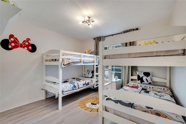 bedroom featuring hardwood / wood-style flooring and a textured ceiling