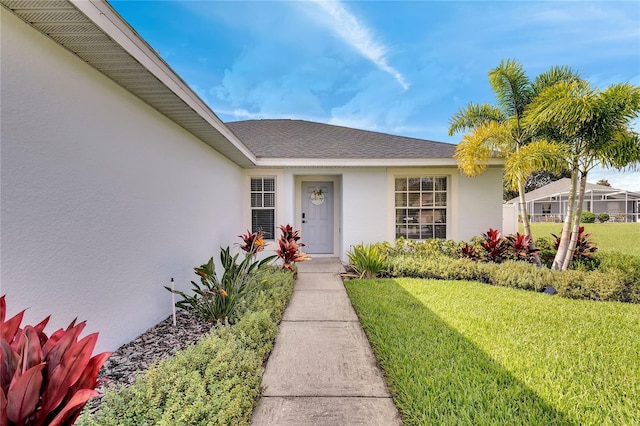 entrance to property with a lawn