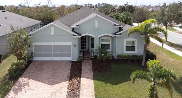 view of front facade with a front lawn and a garage