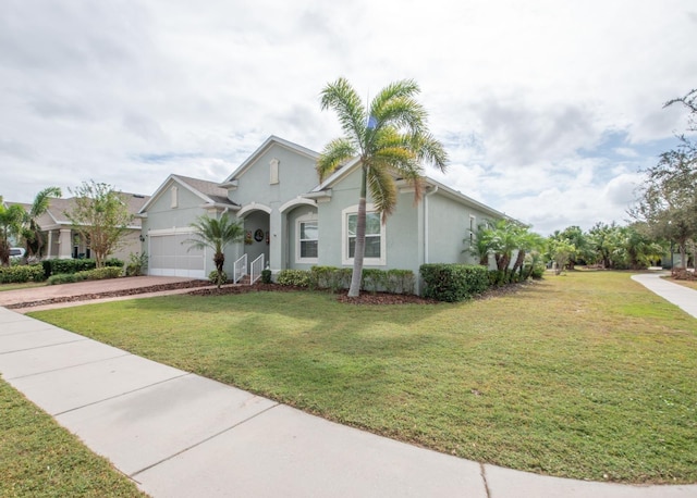 view of front of property with a garage and a front lawn