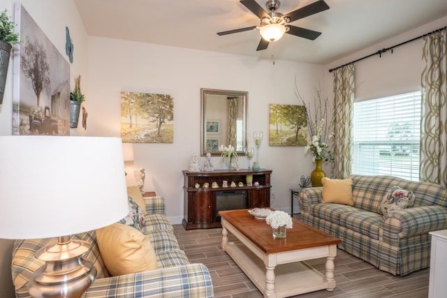 living room with hardwood / wood-style floors and ceiling fan